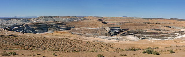 The U.S. Borax Boron Mine is the largest open-pit mine in California. It is probably the largest borate mining operation in the world. The pit is a mile long, half a mile wide and 500-feet deep. The company, a subsidiary of Rio Tinto, extracts several borate minerals from an ancient lakebed that had been buried by alluvium. Near Boron, San Bernardino Co., Calif.